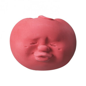 Stress ball with a funny face in the shape and color of a red tomato. 