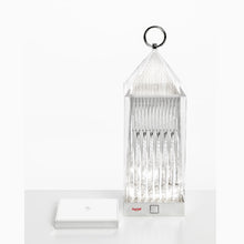 Kartell LED lantern light in crystal color with charging base.