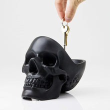 Black skull shaped desk organizer with open skull for holding extra paraphernalia. 