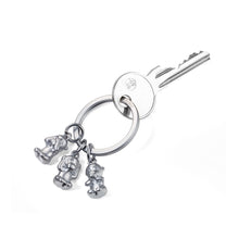 Troika keyring with 3 monkey charms.