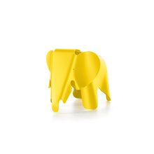 Yellow plastic elephant designed by Charles and Ray Eames.